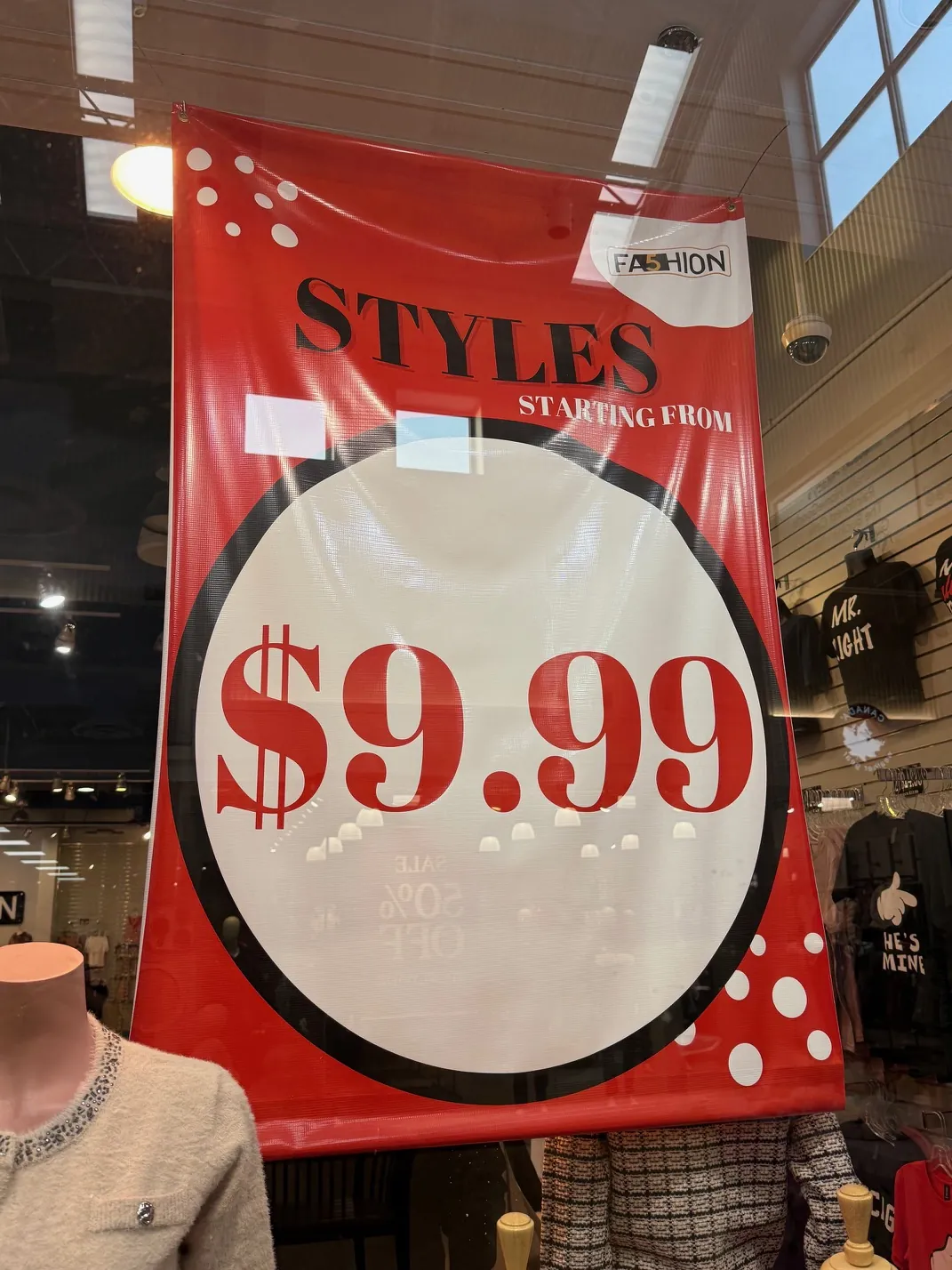 Hanging sale banner in retail store