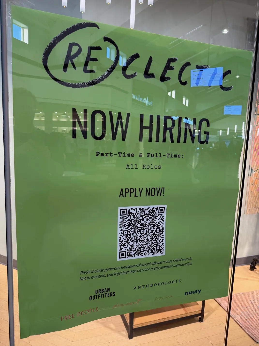 Now hiring banner in store window